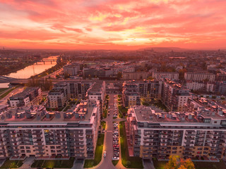 Modern architecture town building in city center. Sunset time, orange and gold light skyline. Drone...