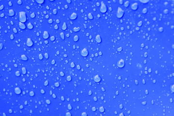 Naklejka na ściany i meble Water Drops Over Blue Background