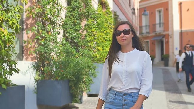 Beautiful woman walks on the old european city