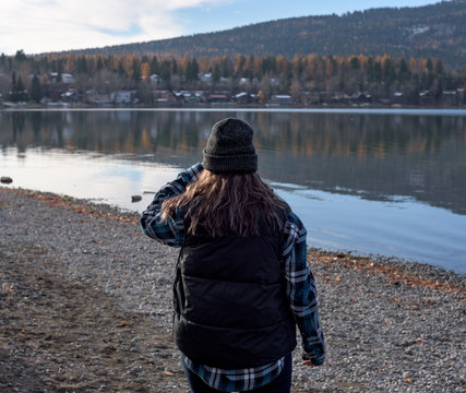 A woman surveys the view next to Whitefish Lake in Montana