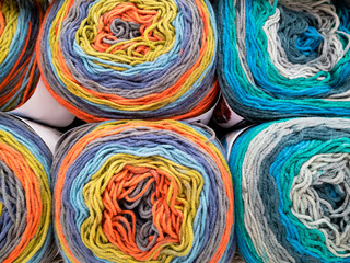 Knitting needles, colorful threads. Knitting pattern of colorful yarn wool on shopfront. Knitting background.