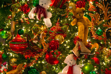 Christmas texture made of the tree hanging ornaments of ball and teddy bear and toys