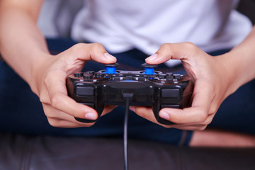 Close up of hand playing video game with a joystick