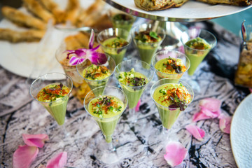 Fototapeta na wymiar Green avocado coctail shots served on catering buffet table