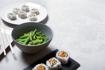 Japanese sushi and green beans on a white background