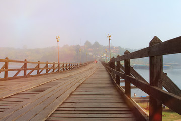 holiday and travel,landscape perspective wood bridge old with mist and sunrise in morning time