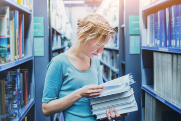 study in university, young student reading book in the library