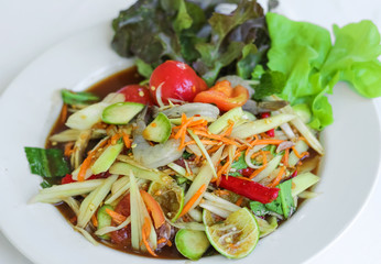 Fresh papaya salad with shrimp and carrot garnish with salad leaf