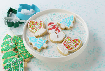 Obraz na płótnie Canvas Festive Christmas snowman Cookie with decorated trees on white background.