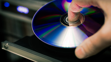 DVD disc inserting to player - obrazy, fototapety, plakaty