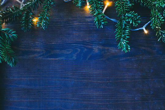 blue cold christmas background with cozy yellow lights and copyspace