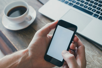 mobile app, closeup of hands holding smartphone with empty white screen