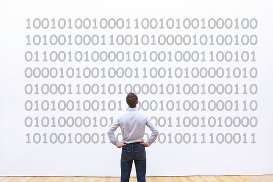 man programmer looking at binary code, coding concept, data encryption