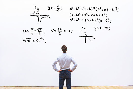 student looking at mathematical formulas, learn maths education concept