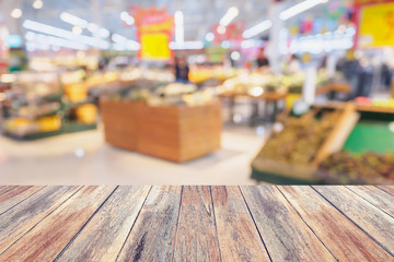 Supermarket with fresh fruits and vegetable on shelves in store blurred background