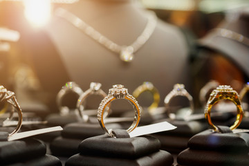 Jewelry diamond rings and necklaces show in luxury retail store window display - obrazy, fototapety, plakaty