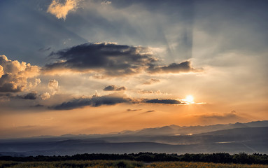 colorful of sunset with sunbeams on top of the mountain