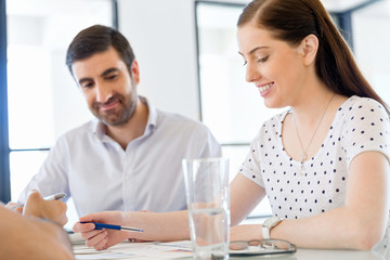 Image of two young business people in office