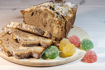 fresh homemade cake dusted with powdered sugar and multi-colored marmalade