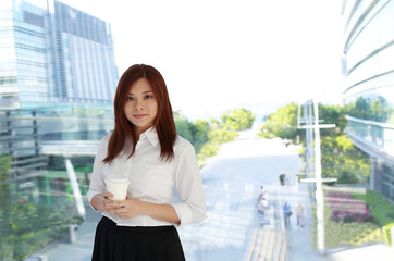 office woman point  with the skyscrapers downtown background