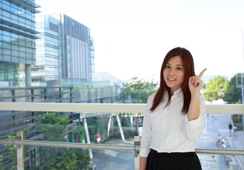 office woman point  with the skyscrapers downtown background