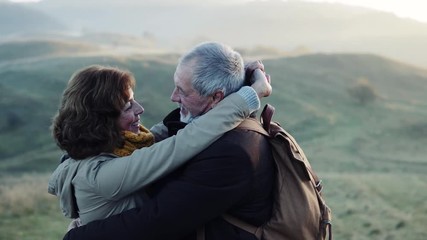 Senior couple on a walk in an autumn nature. - Powered by Adobe