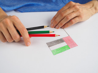 Lady draws the flag of UAE. UAE National Day celebration decorative item.