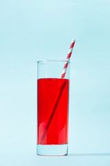 Soft drink. A glass of red soda with ice