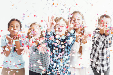 Kids blowing confetti