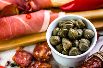 Bowl of capers, italian antipasti, traditional food from italy or mediterranean cuisine ingredient