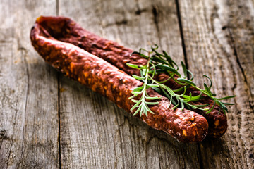 Tapas from spain, chorizo sausage or salami pepperoni, traditional spanish food on wooden table.