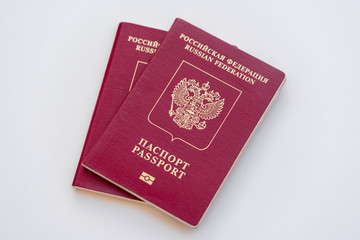 Two red Russian passports on a white background. Isolated