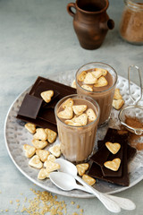 Milk chocolate with Heart Cookies in glasses. Ingredients in the background 
