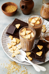 Milk chocolate with Heart Cookies in glasses. Ingredients in the background 
