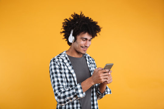 Portrait of happy young african man listening to music