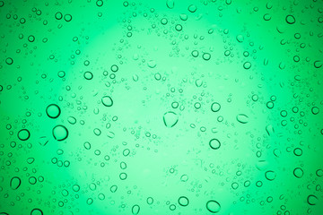 Rain droplets on green glass background, Water drops on glass.