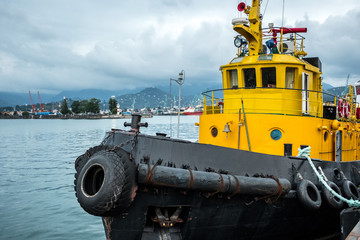 Black and yellow vessel moored at the port