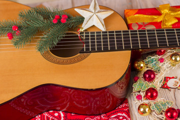 Country music christmas background with guitar and cowboy bandanna