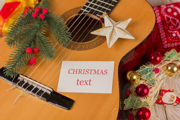 Christmas music card background with guitar and holiday winter decorations