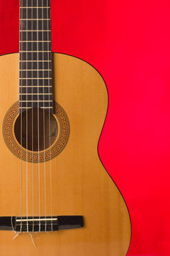 Acoustic guitar on red background