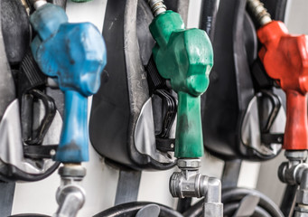 Gasoline and diesel pump nozzles in a gas station closeup. Filling gun, gas refueling nozzle,...