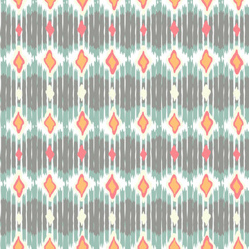 Vector seamless geometric pattern with chevron stripes in ikat fabric style.