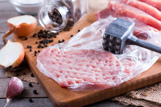 Fresh raw pork chops on chopping board