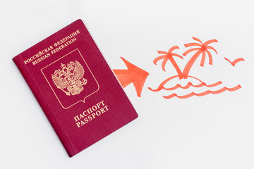 Russian parport lying on white paper with a painted arrow and an island with palm trees