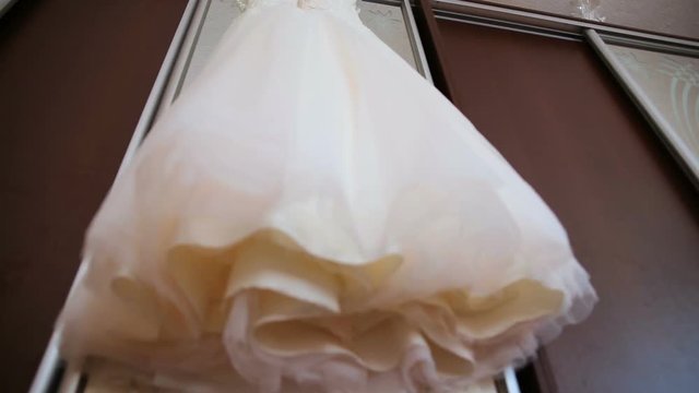 The perfect wedding dress in the room of the bride.
