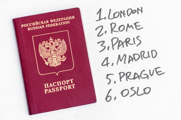 Russian passport near with the European capitals written by the marker