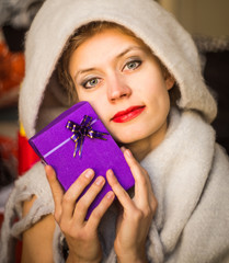 happy woman with a present in her hands smiling