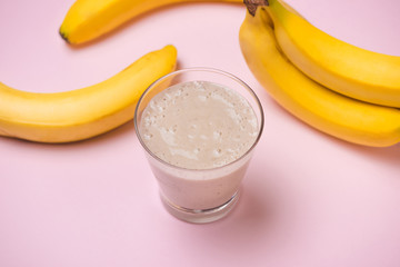 Banana Smoothie on a yellow background. Selective focus