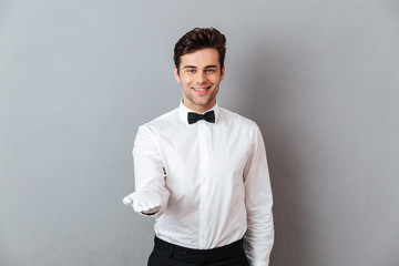 Portrait of a smiling friendly male waiter