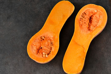 Cut the pumpkin in half on a black background. Top view .